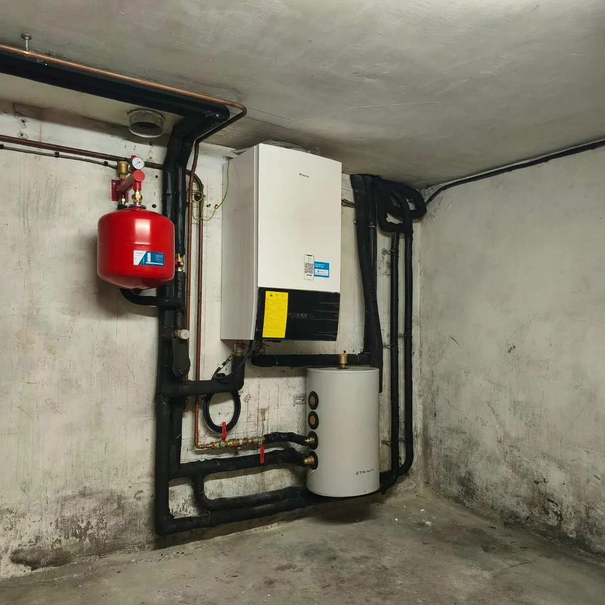 Module hydraulique Daikin mural avec son vase d'expansion rouge, raccordé au réseau de chauffage