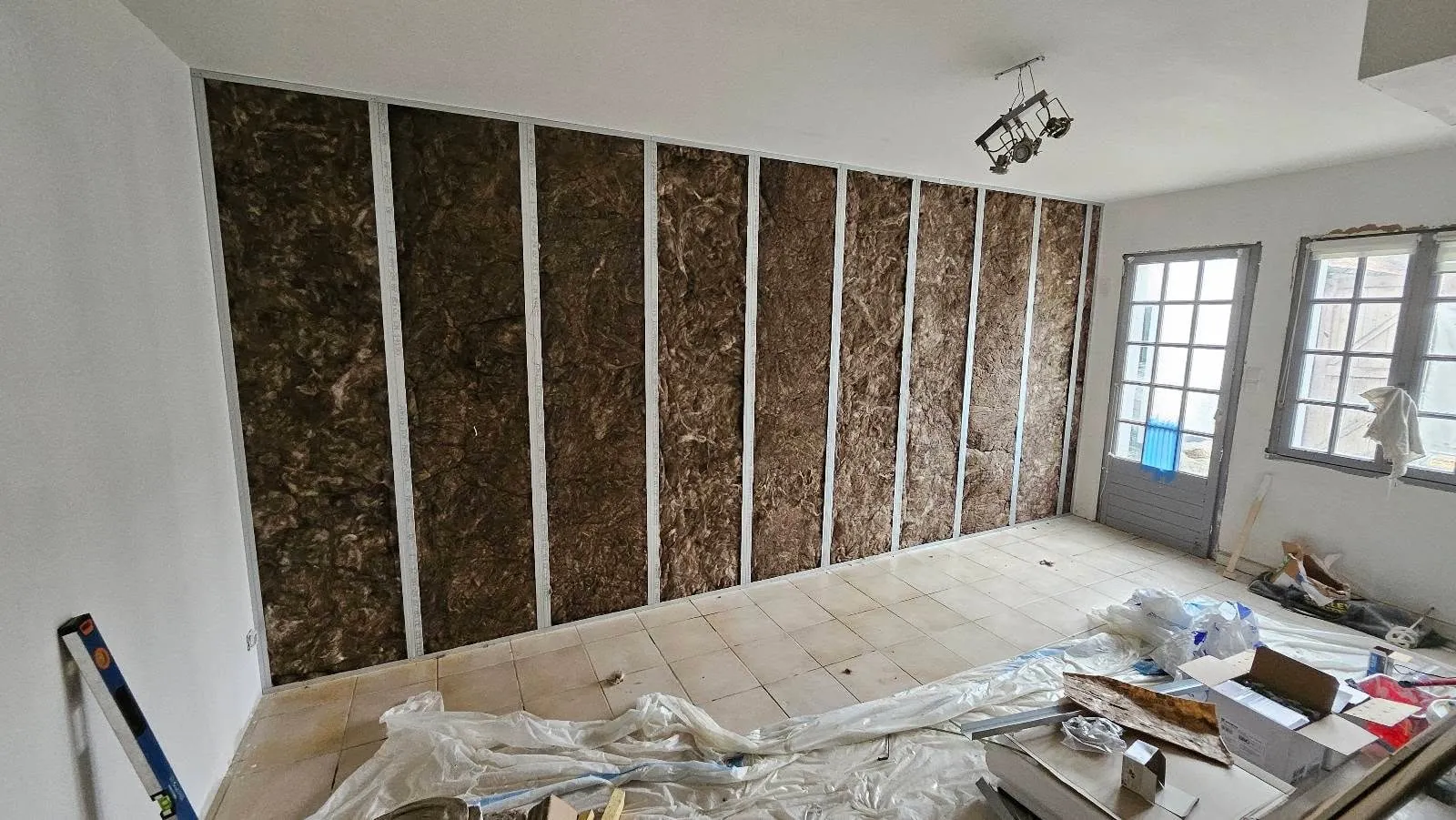 Isolant posé entre les montants d'un mur avant les plaques de plâtre, dans le gîte de Saint-Étienne-au-Mont